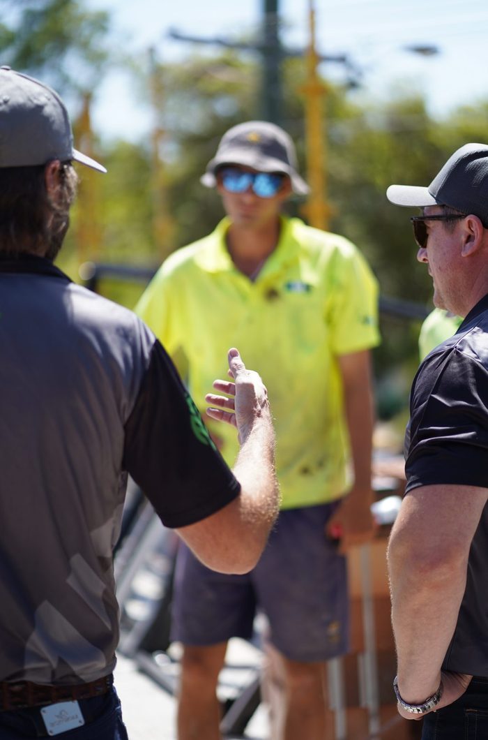 An operator talking with their broker beside plant