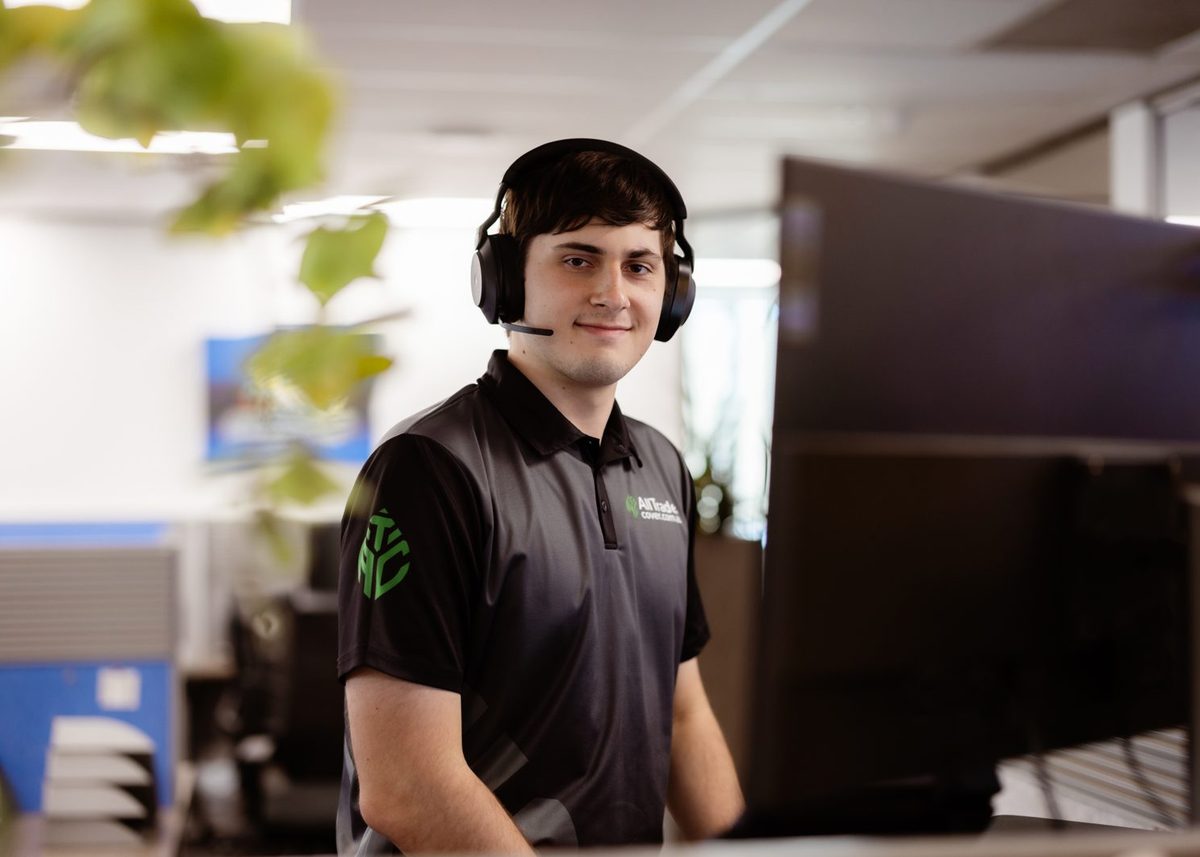 An ATC claims specialist on the phone at their desk